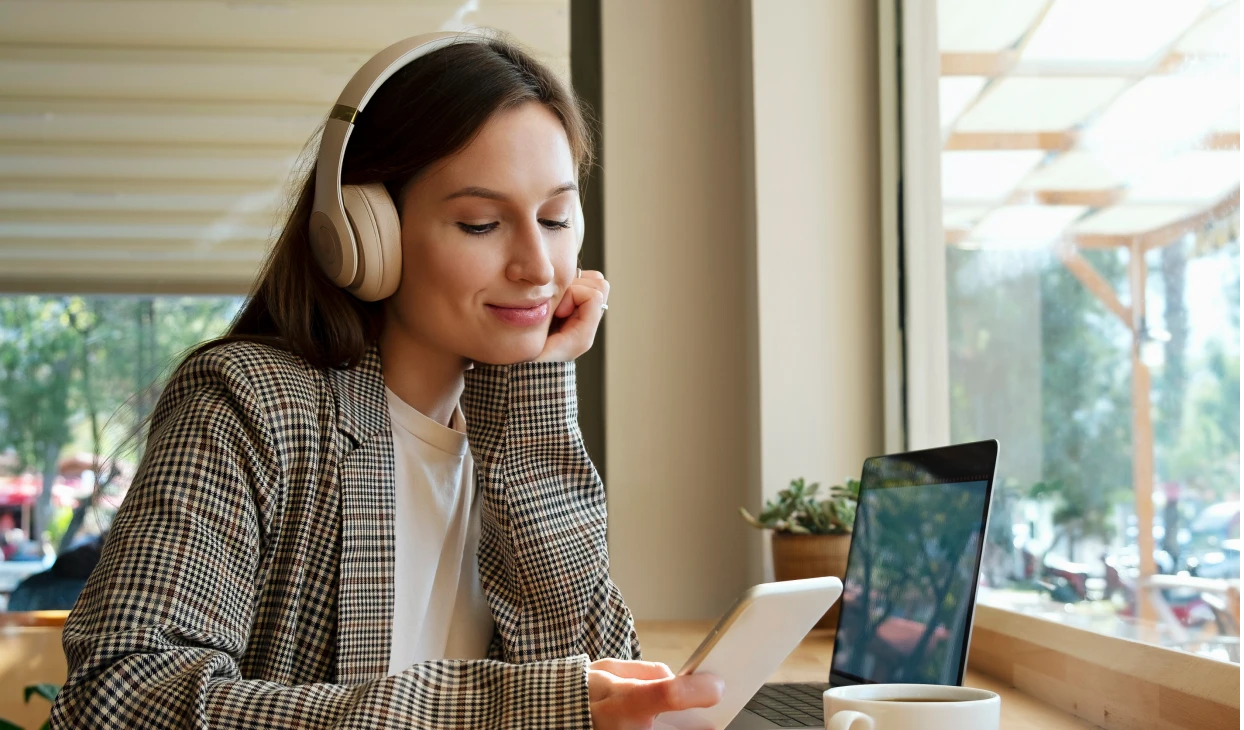 Relaxed woman enjoying music on phone
